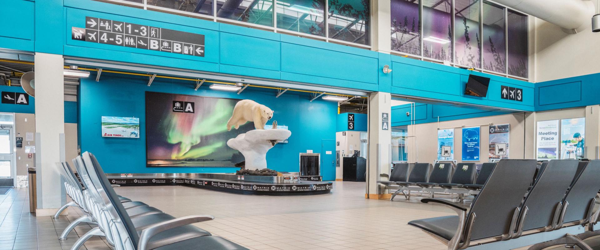 The image depicts the yellowknife airport arrivals area.