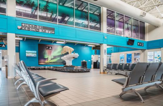 The image depicts the yellowknife airport arrivals area.